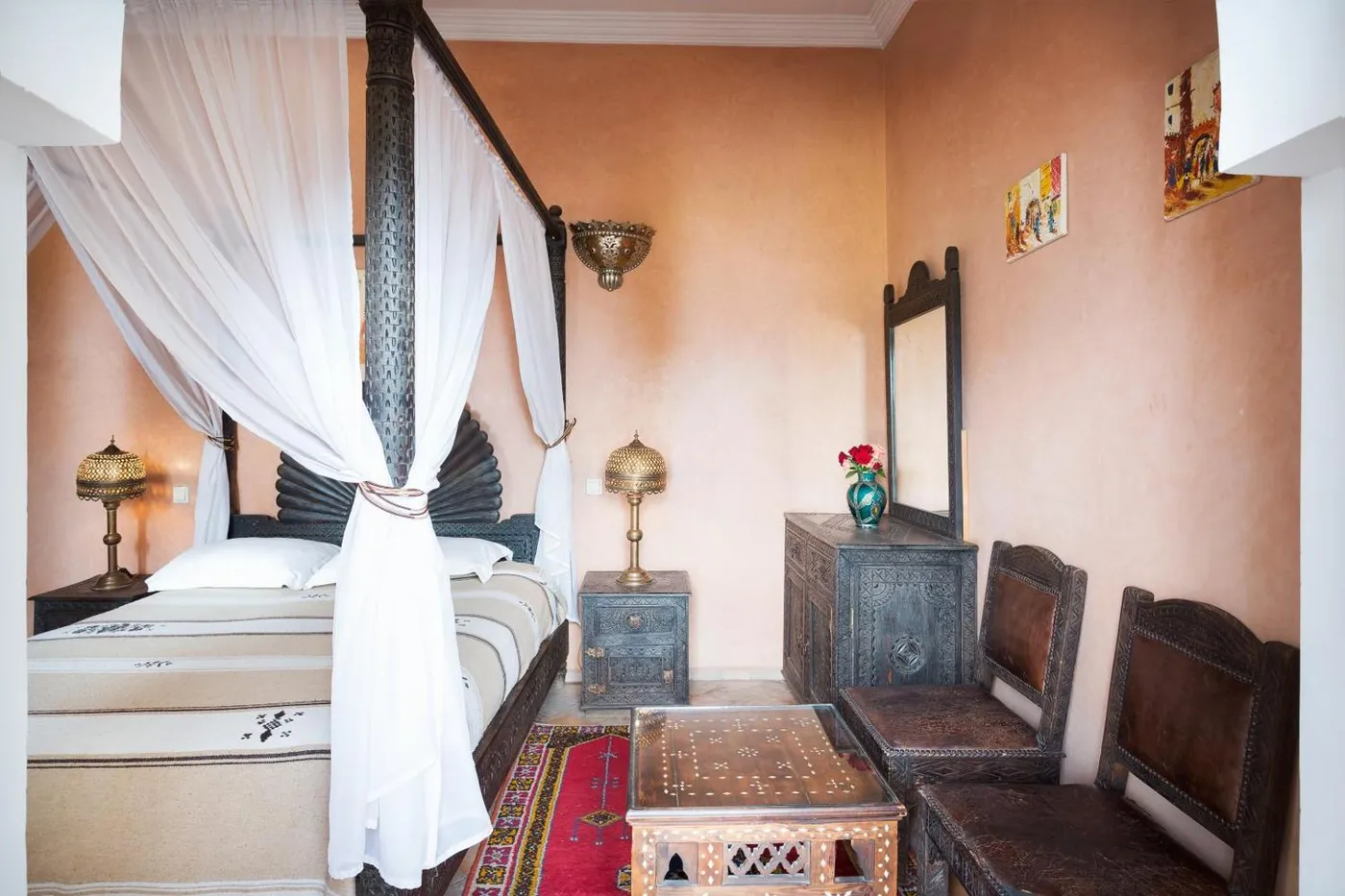 A four-poster bed with tied-back voile