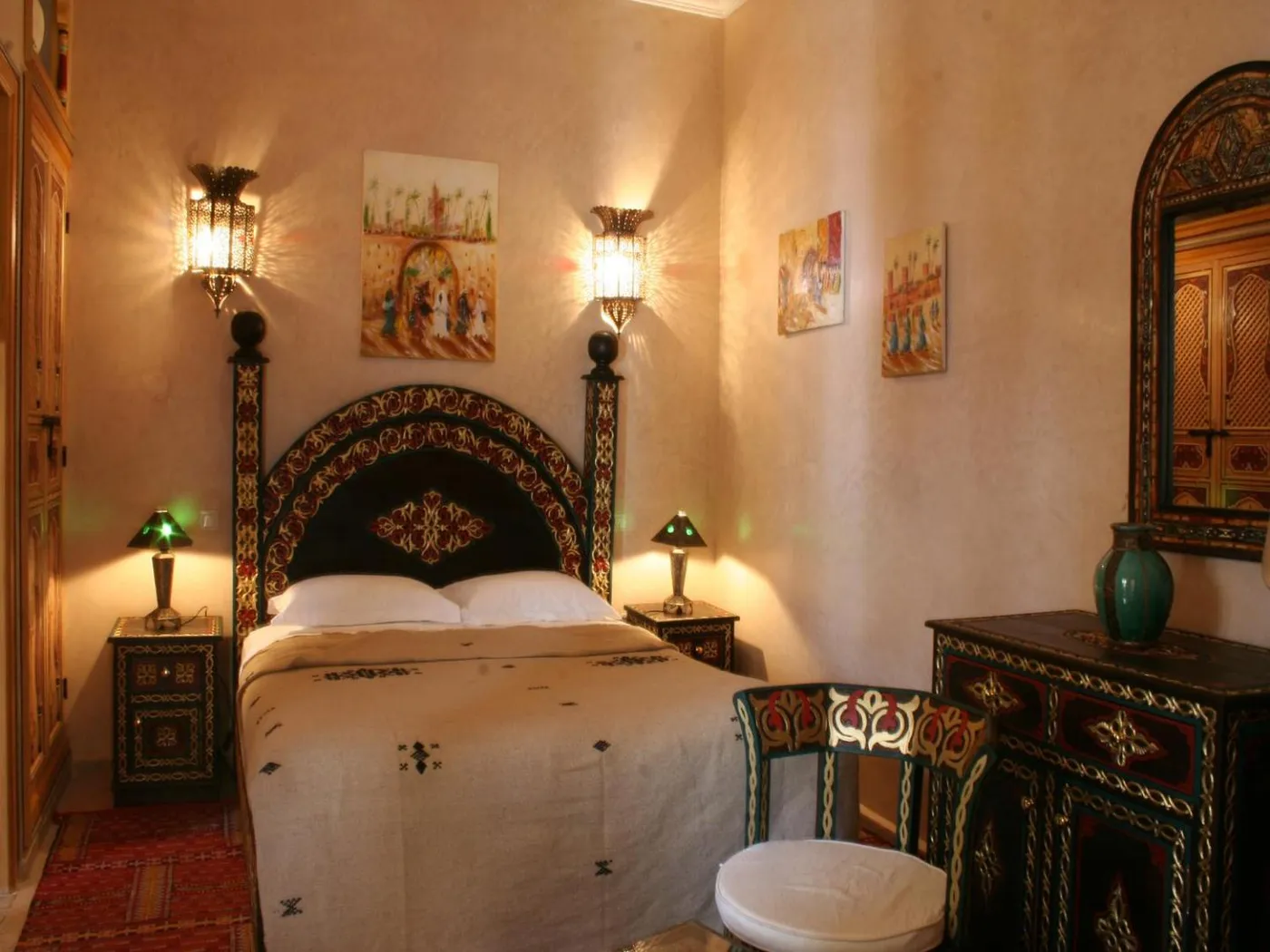 A carved headboard in warm lantern light